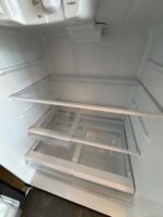 GE 21.9 Cu. Ft. Top-Freezer Refrigerator in Black - Image 4